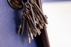 Keychain of keys decor ; detail shot from bathroom remodeling project photo gallery.  Features Custom casings and hand-made rosettes, tone-on-tone floor tile, vintage-inspired lighting and classic chrome plumbing fixtures.