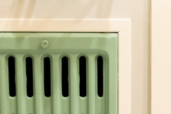 Fun green vent in bright and fun basement bathroom remodel.
