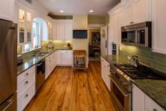 Empty-Nesters’ Kenwood, Minneapolis kitchen remodel - near Lake of the Isles. Contemporary floor plan in traditional space. Features powder room addition 