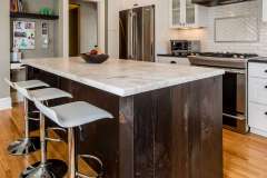 Traditional style kitchen remodel. Factory-style windows and reclaimed wood give textured punch to traditional kitchen addition.  Remodel features additional flex living space, mudroom and powder room.    