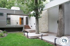 Exterior home remodel with modern look redesign. Remodel features new siding, stone, and cascading Ipe walk.