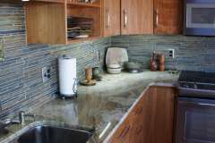 Round condo remodel - eclectic, modern, urban design. Features natural stone, handcrafted ceramic and wood.