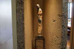 Concrete V shaped wall with statue , detail image, part of round condo remodel photo gallery. Eclectic, modern, urban design, featuring   natural stone, handcrafted ceramic and wood.