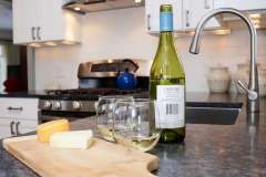 Cutting board with cheese, bottle of wine & two glasses of wine  , part of second story addition home remodel project portfolio.     