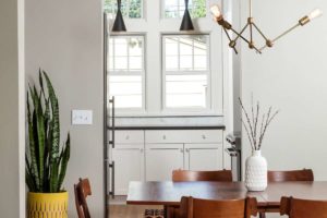 kitchen image. view from dining room into kitchen. white cabinets, neat, modern light fixture