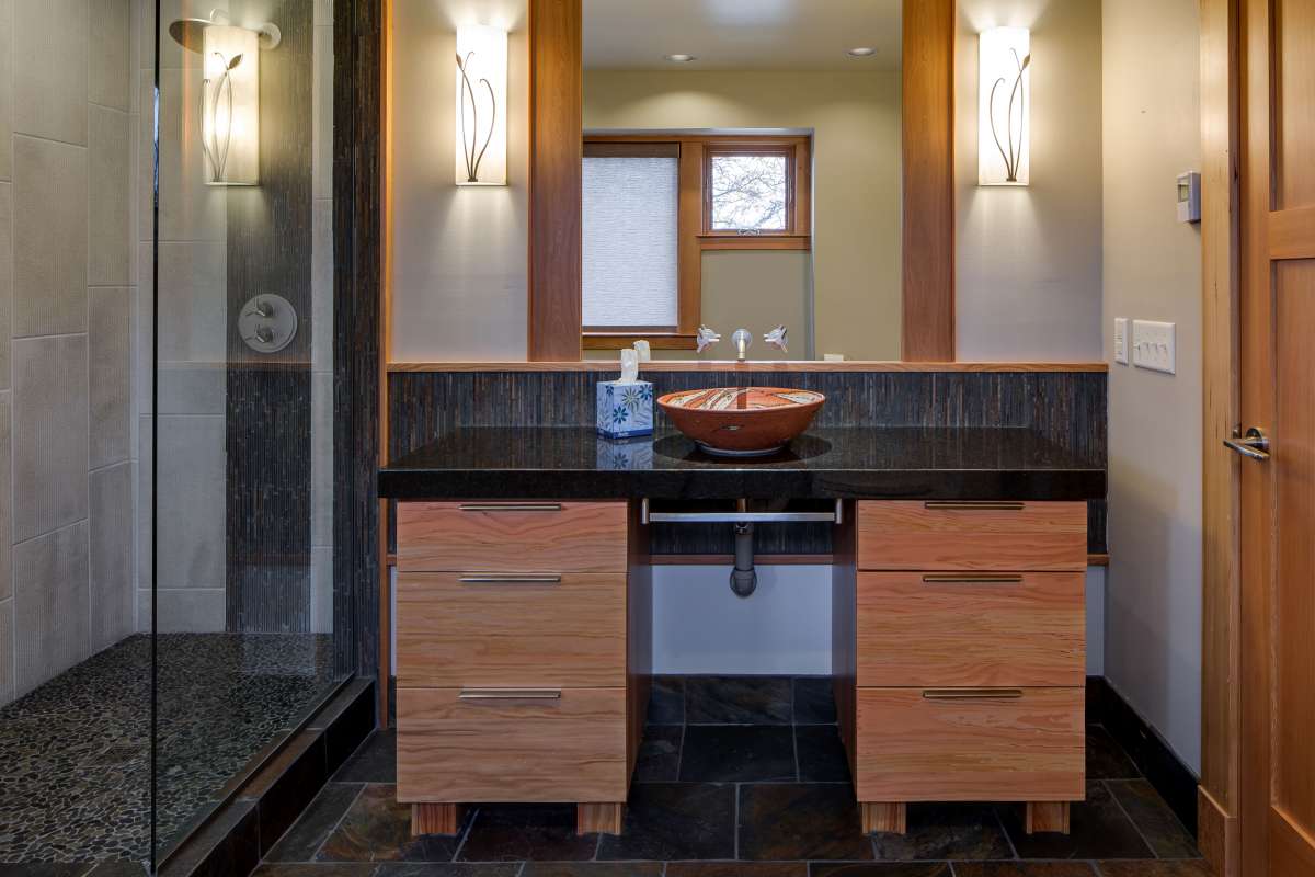 Zen Tranquility created in craftsman style bathroom remodel. Design features warm woods and stone texture.