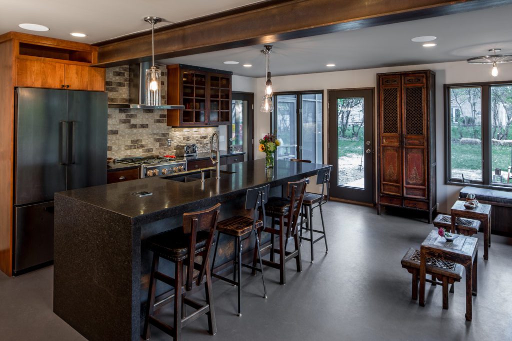 Steampunk Meets Modern kitchen remodel. Features bar-like kitchen island, coffee-shop atmosphere. 