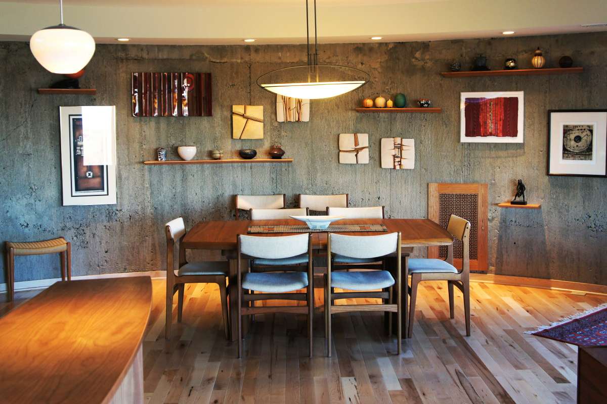 Dining room in round codo remodel, natural stone, wood floor, lots of shelves to display art on walls