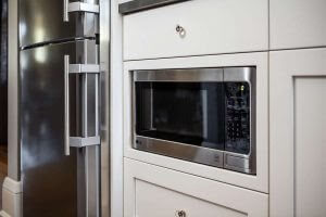 Built-in microwave with white cabinets.