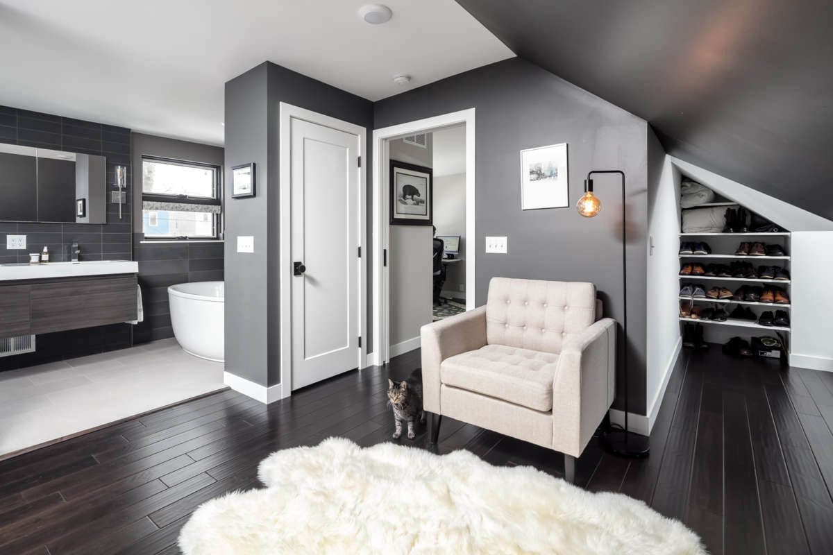 Part of story and a half master bedroom attic expansion with addition. Photo shows cat on floor in modern looking master suite