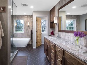 Soaking tub in bathroom, long vanity, bright and sunny, natural colors, varied wood tones. 