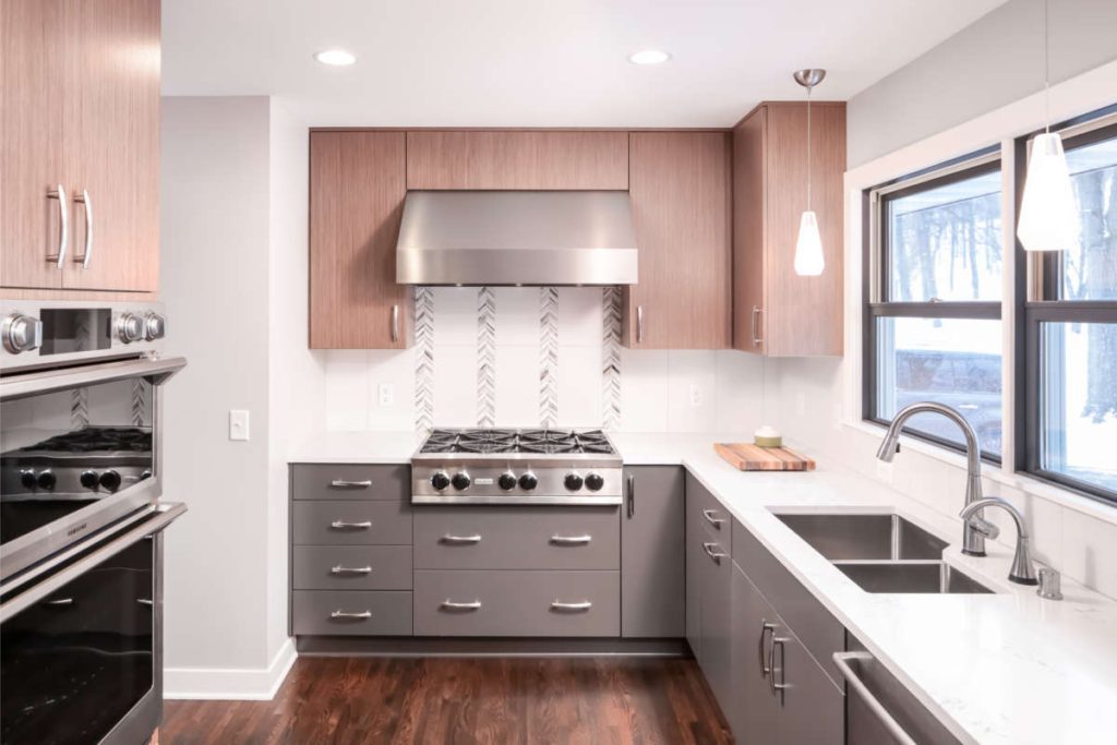 Transpose and Transform: kitchen and dining trade places. Kitchen remodel of 1950's era rambler; modern design in galley kitchen. Unique backsplash.