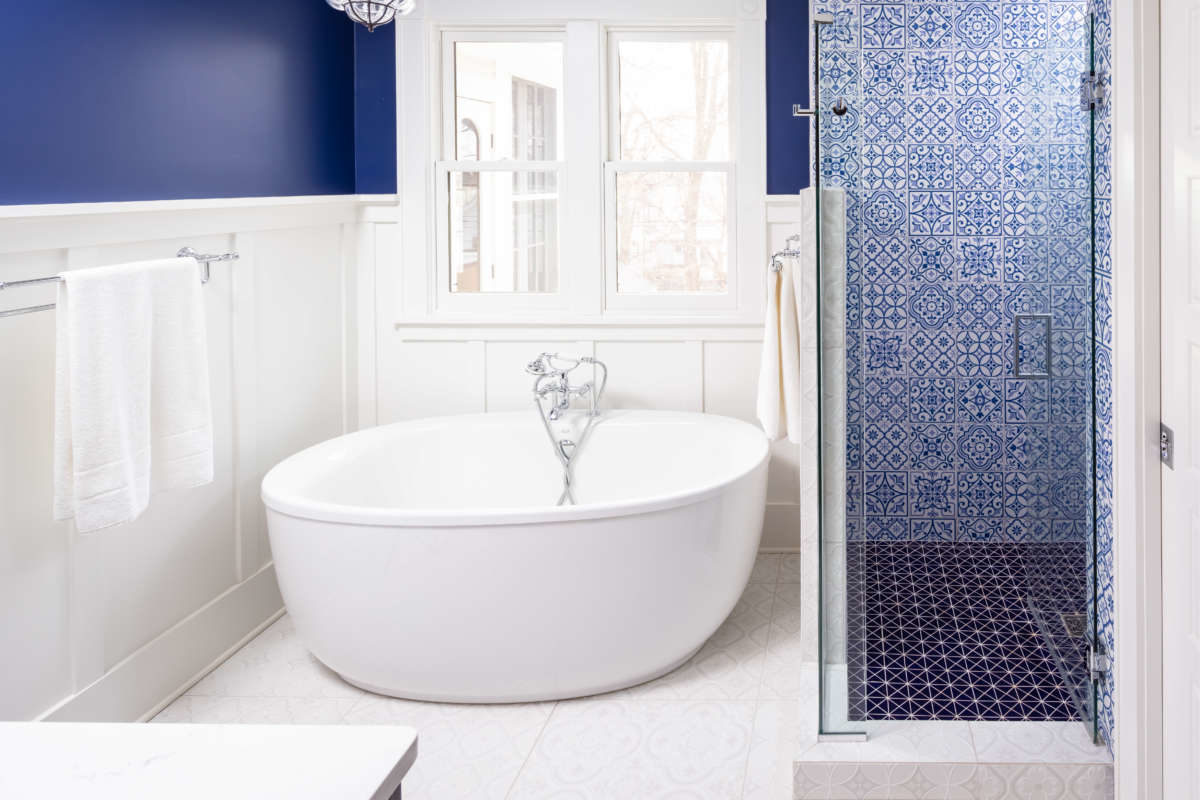 Blue and white bathroom. Contempory style bathroom remodel in classic home. Features custom vanity, two sinks, freestanding soaking tub, separate WC, extra-large luxury shower and lots of storage.
