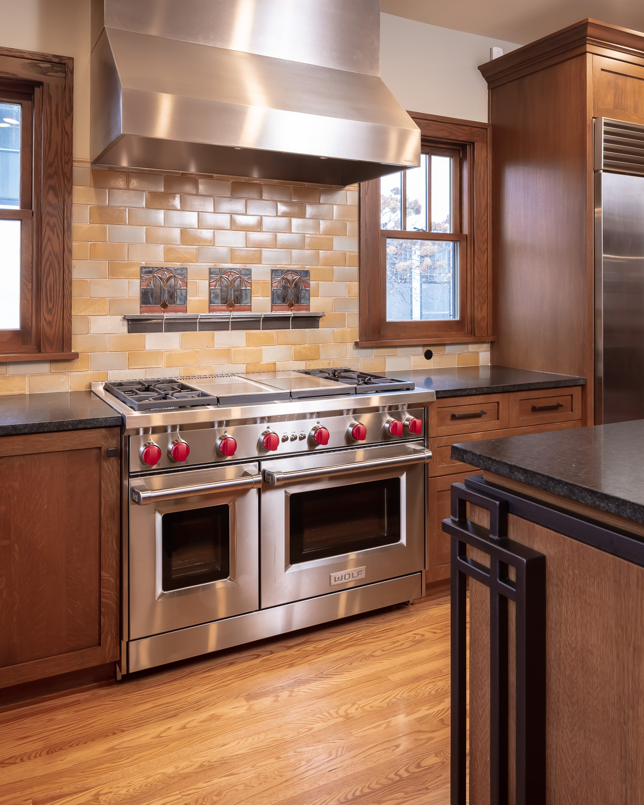 Modern Elegance Meets Historic Charm: Craftsman style kitchen remodel.   Features large square island and L-shaped plan; melds elegance and function into historic architecture.