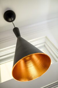 Vintage Brass torpedo sconce light fixture in kitchen remodel , detail image, part of modern kitchen remodel photo gallery. Remodel features custom cabinetry. 