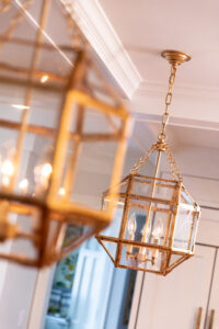 hanging gold and glass pendant lights in bluestem kitchen remodel