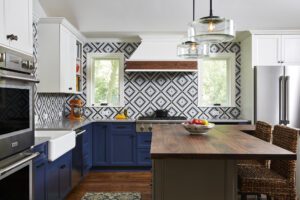 Bluestem award winning Kitchen 2020, unique patterned backsplash, tricolor. Wood island countertop, double oven.