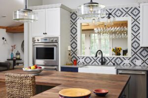 A Kitchen with a View: Kitchen remodel with bump-out addition. Transitional design, features tri-color pallete and island. 