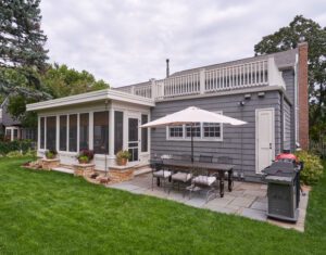 Screenporch addition - exterior view from backyard. Porch and paver patio. New screenporch features custom-sized screens and views of the entire backyard. 