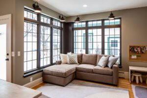 Traditional style kitchen remodel. Factory-style windows and reclaimed wood give textured punch to traditional kitchen addition. Remodel features additional flex living space, mudroom and powder room. 