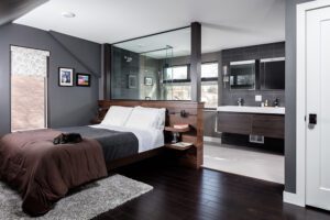 An internationally-inspired attic expansion/addition - Modern style master suite remodel. Cat relaxing on bed. Open concept/loft concept. Features 5-piece bath.   