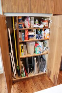 A kitchen cabinet loaded with stuff