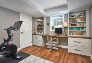 A basement room with books and a treadmill.