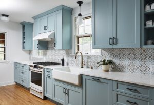 transitional kitchen, light blue custom cabinetry, galley kitchen, unique backsplash design and farmhouse sink