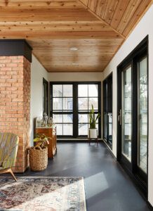 inside 3-Season Screen Porch Addition - view down hallway which connects to living room, past doors to windown with outside