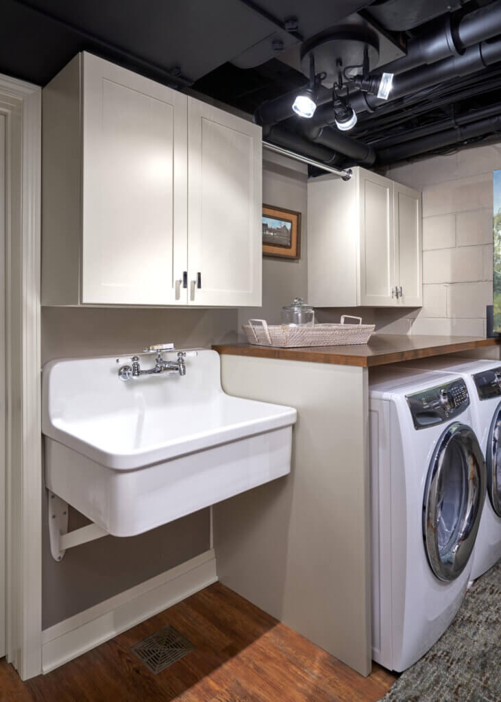 Laundry room with ceiling sconces and white washer and dryer.