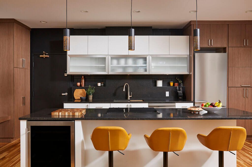 Twin Cities Condo kitchen remodel - sunny kitchen, island, high yellow chairs, sink, pendant lights and cabinets (open and closed shelving)