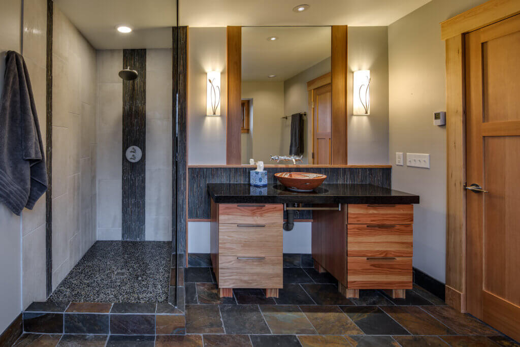 Doorless walk-in shower with black and wooden accents.