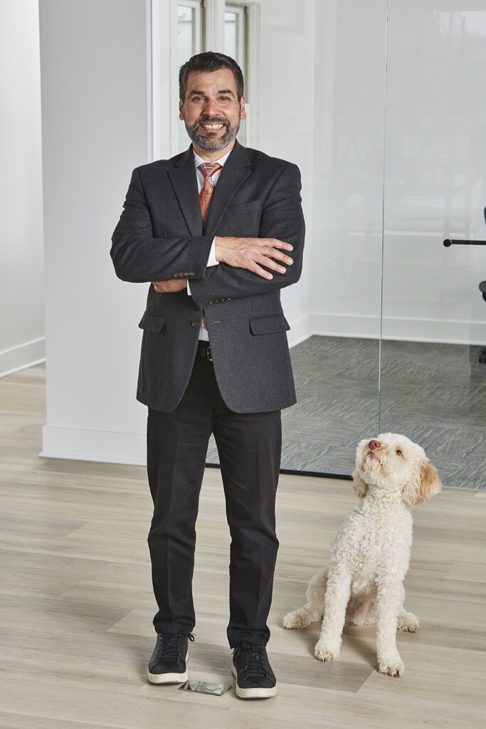 Timothy Ferraro-Hauck, Owner of Bluestem Remodeling with white fluffy Doodle dog