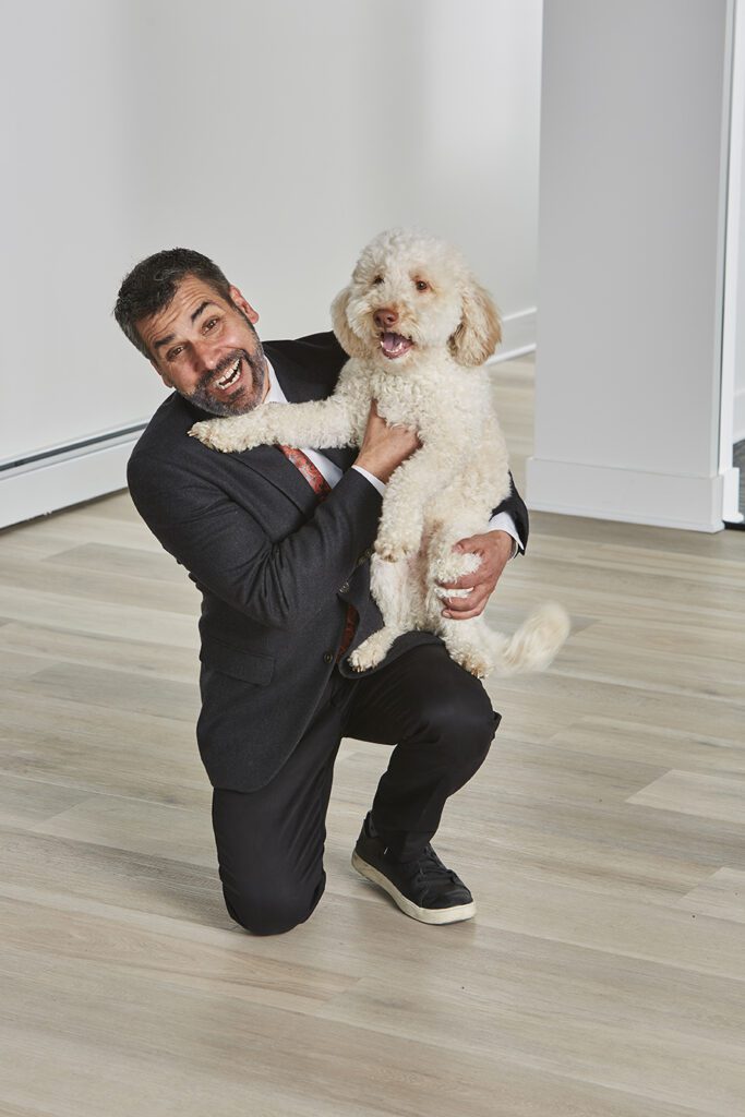 Timothy Ferraro-Hauck, Owner of Bluestem Remodeling with white fluffy Doodle dog